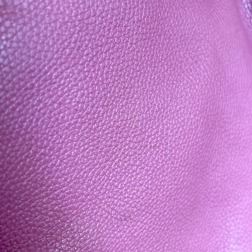 Beautiful and soft light pink leather shoulder bag with a crossbody strap.